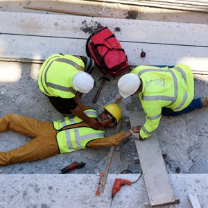 Construction workers helping an injured colleague representing a work injury - Escamilla Law Firm, PLLC