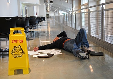 Person slipped on the wet floor, symbolizing a slip and fall injury - Escamilla Law Firm, PLLC